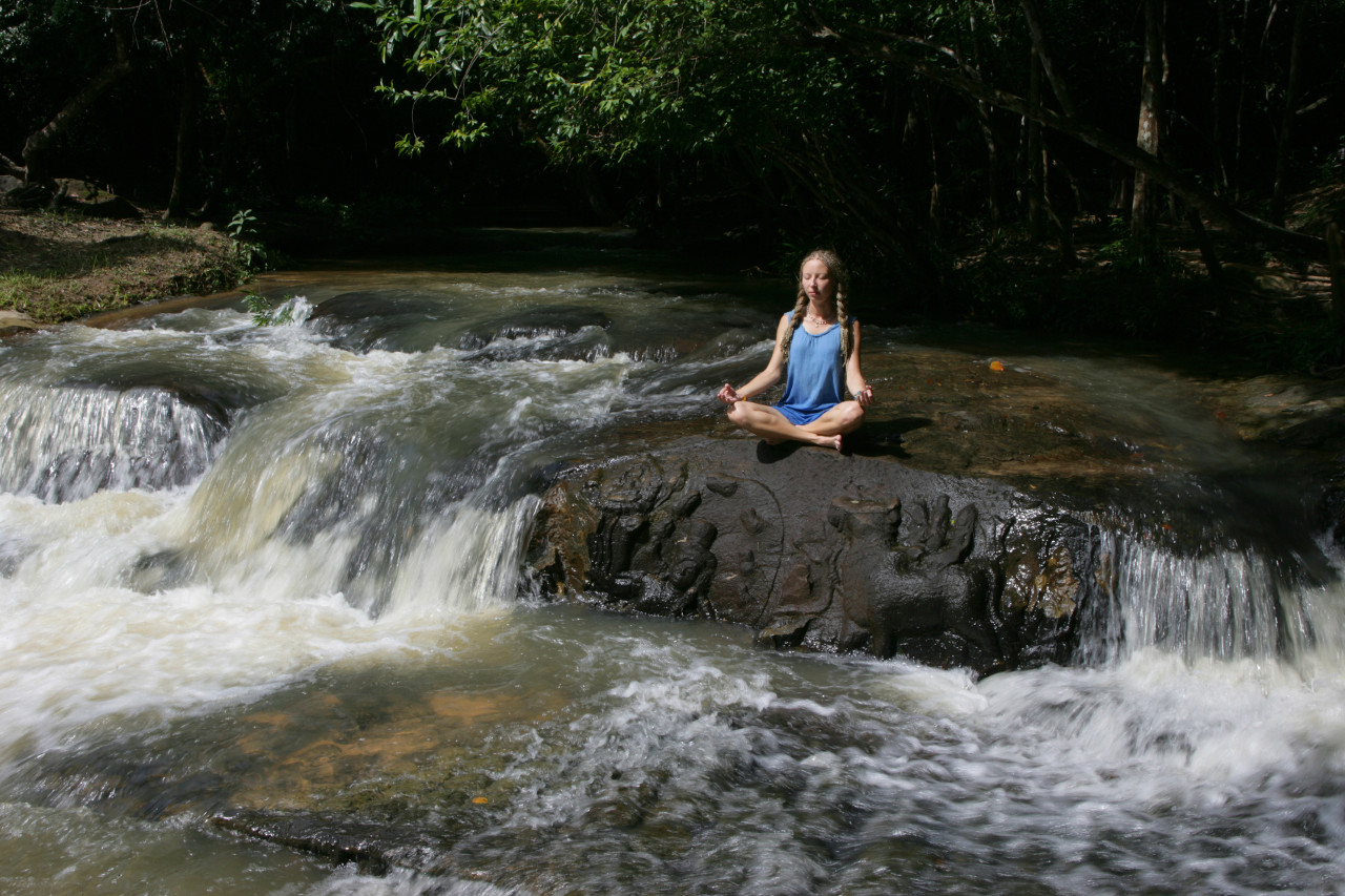Meditating at a waterfall - inner peace when your cash flow is sorted